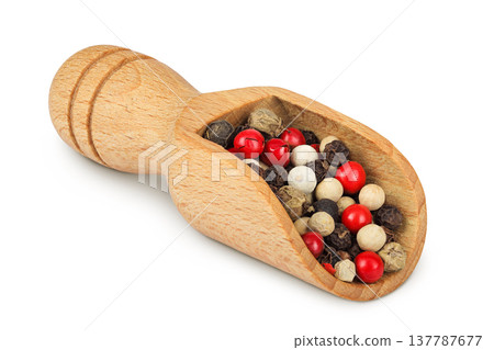 Pepper mix in a wooden scoop isolated on white background. Pepper mix in a wooden scoop isolated on white background. 137787677