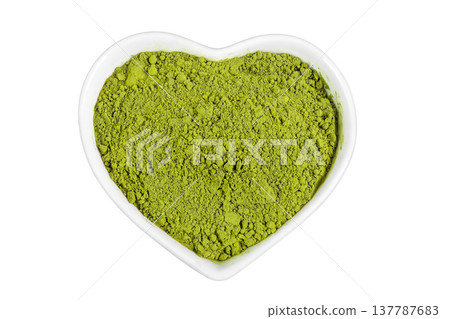 Green matcha powder in ceramic bowl isolated on white background. Top view 137787683