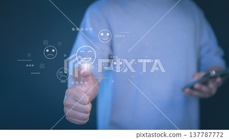 Customer satisfaction and feedback concept with hand showing thumbs up and digital smile rating icon. Represents positive review, user experience, online reputation and business performance evaluation Customer satisfaction and feedback concept with hand showing thumbs up and digital smile rating icon. Represents positive review, user experience, online reputation and business performance evaluation 137787772