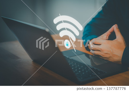 Person using secure WiFi connection on laptop computer. Cybersecurity, private network, and encrypted internet access concept for remote work and digital safety. 137787776