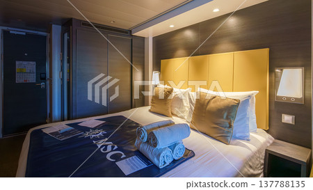 Tokyo, Japan - Oct 2 2024, panoramic view of interior of living cabin with four beds, illuminated by bedside lamps and overhead light, without people, on the MSC Bellissima cruise ship, Tokyo, Japan Tokyo, Japan - Oct 2 2024, panoramic view of interior of living cabin with four beds, illuminated by bedside lamps and overhead light, without people, on the MSC Bellissima cruise ship, Tokyo, Japan 137788135