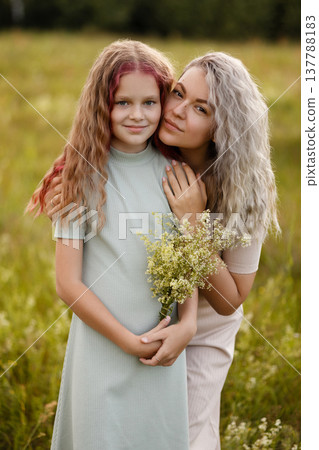 Intimate Scene Of Mother Showing Affection To Her Daughter In Sunlightfilled Meadow 137788183