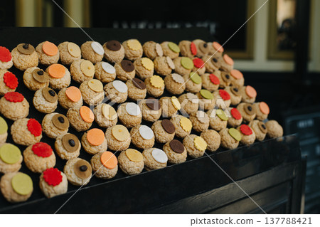 Colorful Choux cakes in a Parisian cafe. French pastries. Colorful Choux cakes in a Parisian cafe. French pastries. 137788421