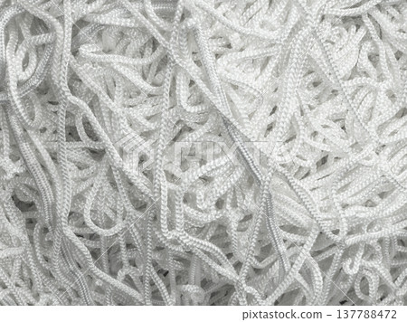 Tangled off-white cords and ropes in industrial setting 137788472