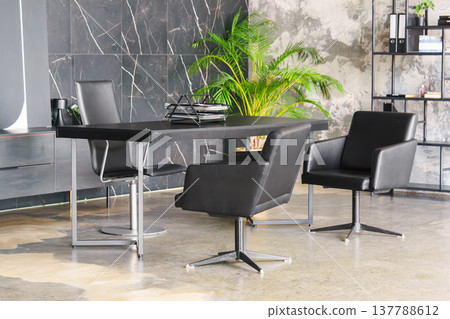 Modern loft office interior with black desk, leather chairs and industrial library shelving Modern loft office interior with black desk, leather chairs and industrial library shelving 137788612
