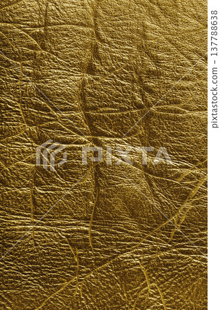 Detailed texture background of yellow colored wrinkled metallic leather with natural creases Detailed texture background of yellow colored wrinkled metallic leather with natural creases 137788638