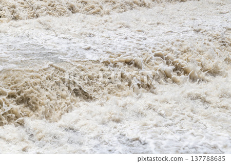 Turbulent water flowing in a chaotic river during daytime Turbulent water flowing in a chaotic river during daytime 137788685