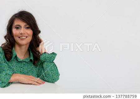 Happy professional portrait, Confident woman with friendly smile, Elegant brunette woman in green blouse exhibiting confidence and approachability in studio setting Happy professional portrait, Confident woman with friendly smile, Elegant brunette woman in green blouse exhibiting confidence and approachability in studio setting 137788759