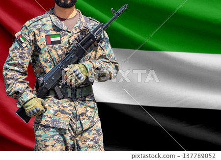 United Arab Emirates flag with soldier holding assault rifle 137789052