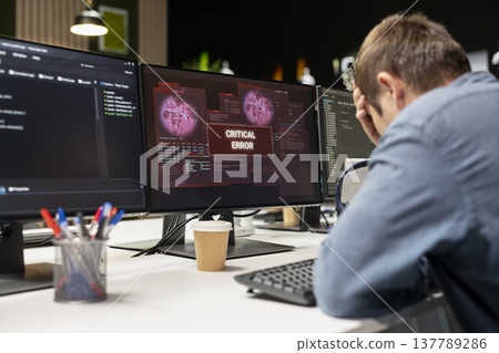 Engineer in startup office doing facepalm, worried after struggling to fix application errors while coding. Distressed IT worker troubled by computer bugs while coding in software development agency Engineer in startup office doing facepalm, worried after struggling to fix application errors while coding. Distressed IT worker troubled by computer bugs while coding in software development agency 137789286