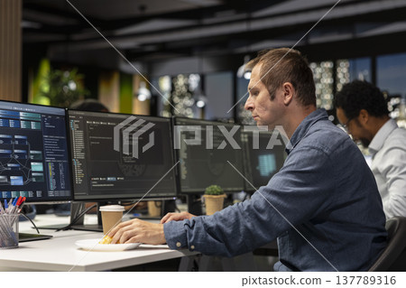 Software developer writing code, developing machine learning APIs. IT professional in tech startup working to troubleshoot software errors using artificial intelligence, resolving system crashes Software developer writing code, developing machine learning APIs. IT professional in tech startup working to troubleshoot software errors using artificial intelligence, resolving system crashes 137789316