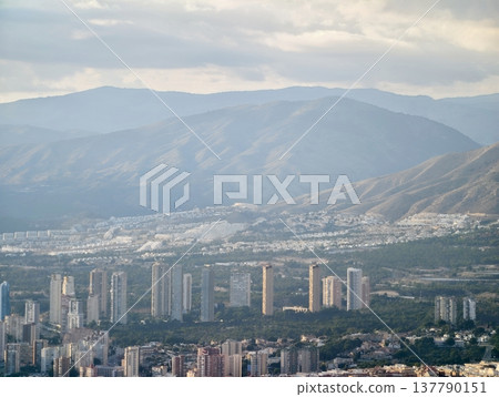 Highrise Homes By Green Hills, Urban Towers Overlooking Lush Green Slopes And Suburban Regions Highrise Homes By Green Hills, Urban Towers Overlooking Lush Green Slopes And Suburban Regions 137790151