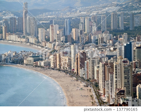 Sunlit Shoreline With Towering Hotels, Cityscape Featuring Sundrenched Beaches And Surrounding Mountains Sunlit Shoreline With Towering Hotels, Cityscape Featuring Sundrenched Beaches And Surrounding Mountains 137790165