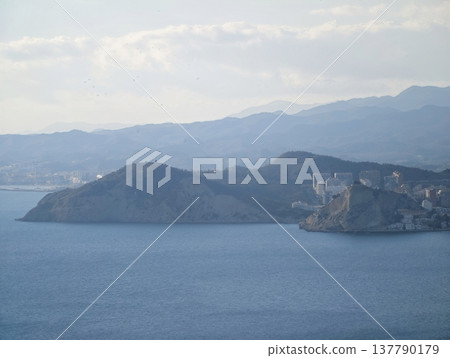 Calm Sea Surrounds Historic Isle, Serene Maritime Landscape With Heritage Site And Rugged Cliffs 137790179