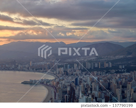 Peaceful Dusk Scene Showing Layered City Ridges And Distant Hill Silhouettes Against Calm Waters Peaceful Dusk Scene Showing Layered City Ridges And Distant Hill Silhouettes Against Calm Waters 137790199
