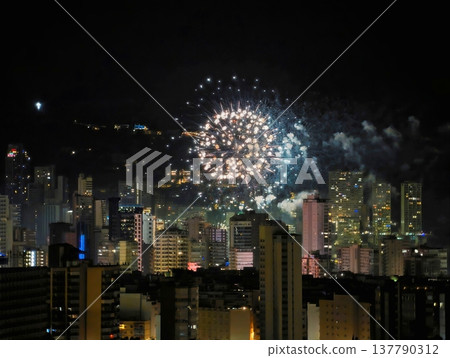 City Fireworks Display, Residential Buildings Glow As Fireworks Burst In Vibrant Colors Overhead City Fireworks Display, Residential Buildings Glow As Fireworks Burst In Vibrant Colors Overhead 137790312