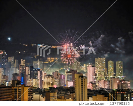 Nighttime Cityscape Features Vibrant Fireworks Bursting Amidst Neon Signs And Lively Community Celebrations Nighttime Cityscape Features Vibrant Fireworks Bursting Amidst Neon Signs And Lively Community Celebrations 137790325