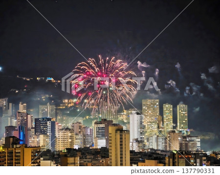 Cities Glow Festively, Bright Fireworks Blossom Across Cityscape With Glowing Petals And Reflections Cities Glow Festively, Bright Fireworks Blossom Across Cityscape With Glowing Petals And Reflections 137790331