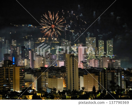 Calm Night With Fireworks Over City, Tranquil Urban Night Illuminated By Distant Explosions 137790369