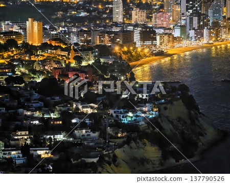 City Lights Glow, Vibrant Coastal Cityscape Illuminated By Towering High Rises And Bustling Streets 137790526