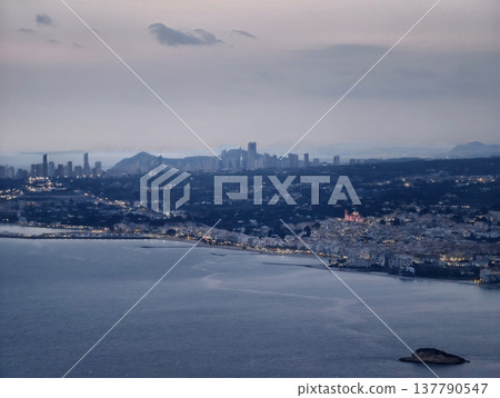 Twilight Harbor With Bustling Activity, Vibrant Port Scene With Cranes And Glowing Reflections At Dusk 137790547