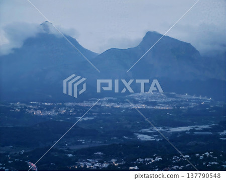 Sunset Peaks Over Bright Valley, Dusk Time Mountain View With Foggy Summits And Luminous Valley Scene 137790548
