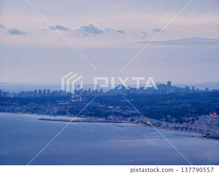 Harbor Nighttime Activity, Nighttime Industrial Port Scene With Cranes And Shimmering City Lights 137790557