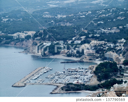 Picturesque Shoreline Village With Terraced Roofs And Winding Routes Descending To Peaceful Waters Picturesque Shoreline Village With Terraced Roofs And Winding Routes Descending To Peaceful Waters 137790569