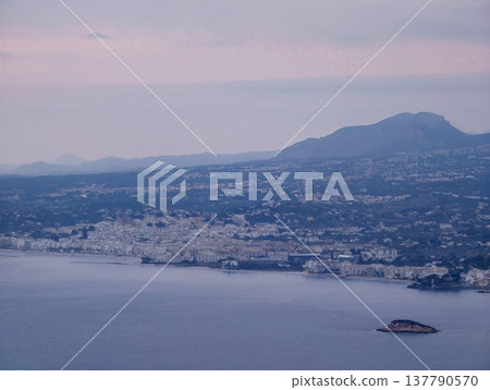 Coastal Dawn Scenery, Early Morning Over Calm Shoreline Featuring Pastel Sky And Distant Mountain Views Coastal Dawn Scenery, Early Morning Over Calm Shoreline Featuring Pastel Sky And Distant Mountain Views 137790570