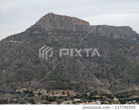 Majestic Mountain Plateau Above Quaint Village Surrounded By Limestone Ridges And Sparse Vegetation 137790595