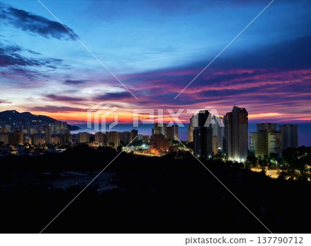 Bright Skyscrapers Glow At Sunset, Sunset City Skyline Showcases Luminous Buildings And Vivid Sky Colors Bright Skyscrapers Glow At Sunset, Sunset City Skyline Showcases Luminous Buildings And Vivid Sky Colors 137790712