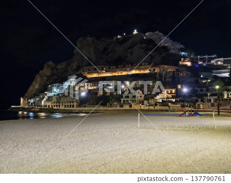 Serene Coastal Scene, Peaceful Evening At Coast Featuring Silent Beaches And Illuminated Cliff Houses 137790761