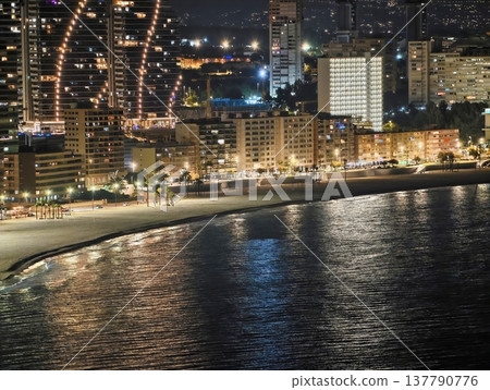 Serene Waterfront Cityscape Featuring Illuminated Curved Skyscrapers And Rhythmic Lighting Displays Serene Waterfront Cityscape Featuring Illuminated Curved Skyscrapers And Rhythmic Lighting Displays 137790776