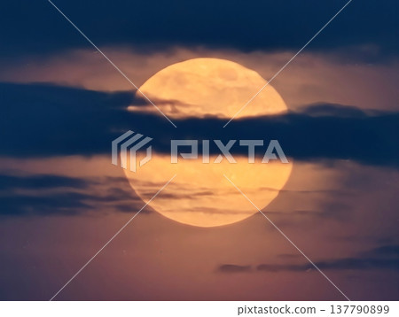 Bright Moon Emerging Among Thin Clouds, Luminous Orange Moon Breaking Through Delicate Cloud Formations 137790899