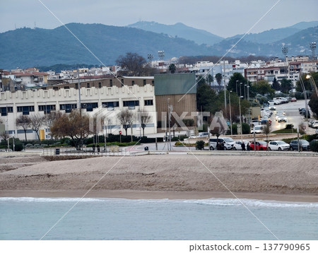 Tranquil Coastal Village By Mountains, Peaceful Beach Scene With Distant Mountainous Backdrop Tranquil Coastal Village By Mountains, Peaceful Beach Scene With Distant Mountainous Backdrop 137790965