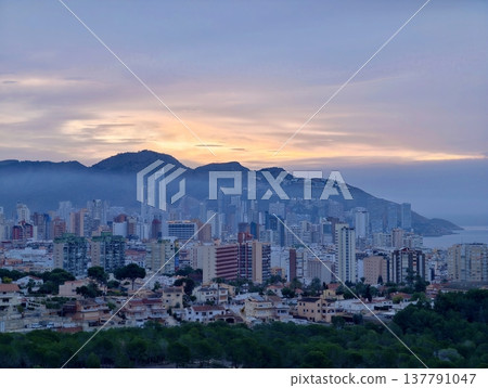 Urban Horizon With Coastal Glow, Serene Urban Seascape Featuring Distant Buildings And Twilight Hues Urban Horizon With Coastal Glow, Serene Urban Seascape Featuring Distant Buildings And Twilight Hues 137791047