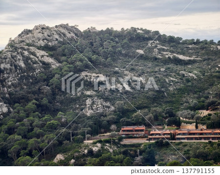 Terraced Houses Beside Rocky Slopes, Sunrise Shadows Cast Over Cliffside Homes Blending Into Rocks Terraced Houses Beside Rocky Slopes, Sunrise Shadows Cast Over Cliffside Homes Blending Into Rocks 137791155