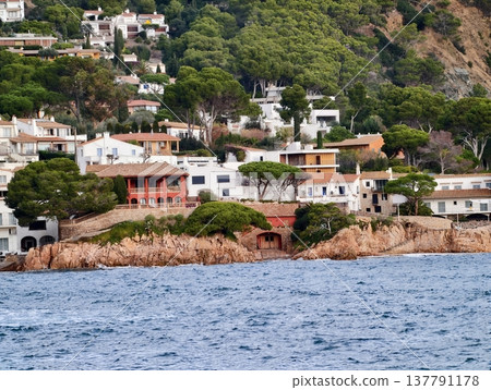 Colorful Houses Dotted Along Jagged Shoreline Featuring Terraces And Brightly Painted Exteriors Colorful Houses Dotted Along Jagged Shoreline Featuring Terraces And Brightly Painted Exteriors 137791178