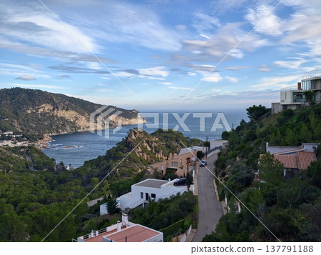 Picturesque Street Overlooking Bay, Curving Road Passing Terracotta Rooftops Toward Oceanfront Villas Picturesque Street Overlooking Bay, Curving Road Passing Terracotta Rooftops Toward Oceanfront Villas 137791188