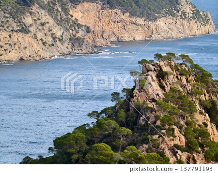 Trail Leading Through Dramatic Coastal Formations Towards Distant Headlands And Vibrant Blue Waters Trail Leading Through Dramatic Coastal Formations Towards Distant Headlands And Vibrant Blue Waters 137791193