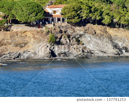 Serene Rocky Coastline With Scenic Villa, Tranquil Retreat Overlooking Shimmering Turquoise Sea 137791253