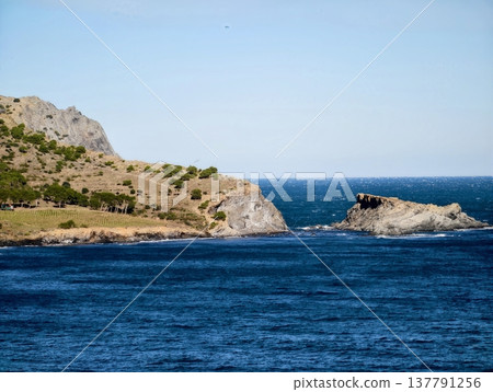 Serene Inlet Surrounded By Rugged Rocks, Tranquil Waterway Framed By Cliffs Leading To Ocean Serene Inlet Surrounded By Rugged Rocks, Tranquil Waterway Framed By Cliffs Leading To Ocean 137791256