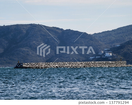 Quiet Shoreline With Towering Mountain Scene, Peaceful Oceanfront With Rocky Barrier And Distant Peaks Quiet Shoreline With Towering Mountain Scene, Peaceful Oceanfront With Rocky Barrier And Distant Peaks 137791294