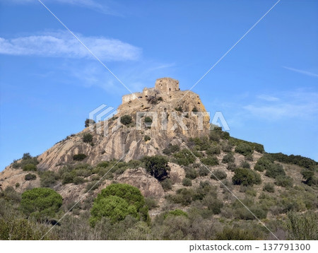 Old Stone Fortress Atop Rugged Slope, Medieval Ruins Perched On Remote Hillside Bathed In Sunlight Old Stone Fortress Atop Rugged Slope, Medieval Ruins Perched On Remote Hillside Bathed In Sunlight 137791300