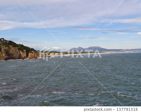 Serene Seaside Scene Featuring Gentle Waves, Calm Bay Overlooking Cliffs And Lush Green Promontory Serene Seaside Scene Featuring Gentle Waves, Calm Bay Overlooking Cliffs And Lush Green Promontory 137791318