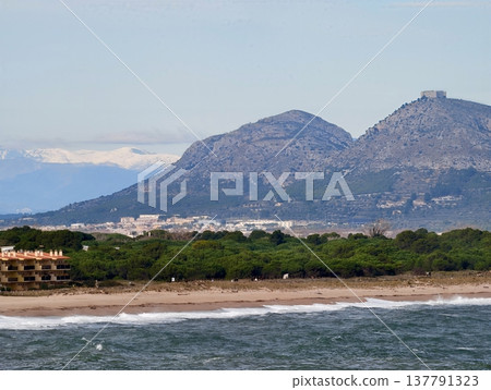 Idyllic Coastal Scene Showcasing Village At Mountain Base With Turquoise Waters And Natural Surroundings Idyllic Coastal Scene Showcasing Village At Mountain Base With Turquoise Waters And Natural Surroundings 137791323