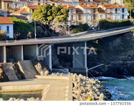 Coastal Cliffs With Vibrant Sunrise, Serene Dawn On Rocky Coast With Colorful Rooftops And Calm Blue Sea Coastal Cliffs With Vibrant Sunrise, Serene Dawn On Rocky Coast With Colorful Rooftops And Calm Blue Sea 137791556