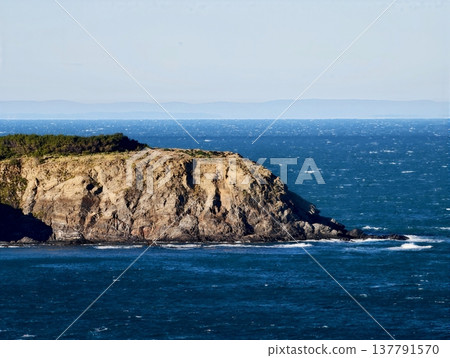 Harbor Quiet And Boats Peacefully Anchored, Marina Rests In Calm Bay Beneath Scenic Cliff Path 137791570