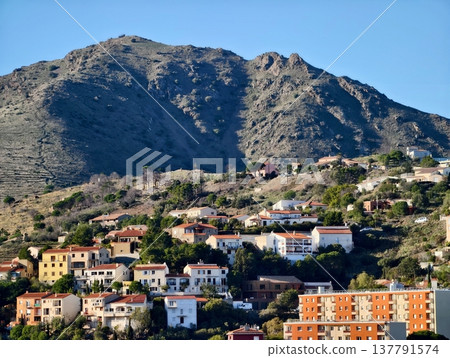 Vibrant Hillside Settlement With Gardens, Colorful Village On Slope With Lush Green Surroundings Vibrant Hillside Settlement With Gardens, Colorful Village On Slope With Lush Green Surroundings 137791574