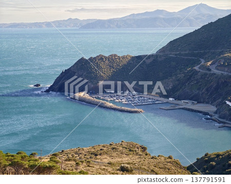 Peaceful Harbor Under Open Sky, Tranquil Bay With Distant Mountain Outlines And Bright Daylight 137791591